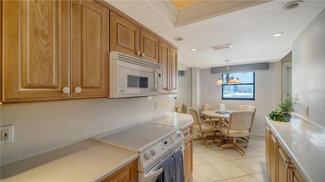 kitchen featuring light tile patterned floors, white appliances, decorative backsplash, a textured ceiling, and decorative light fixtures