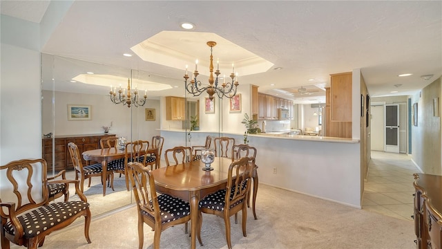 carpeted dining area featuring a raised ceiling and a chandelier