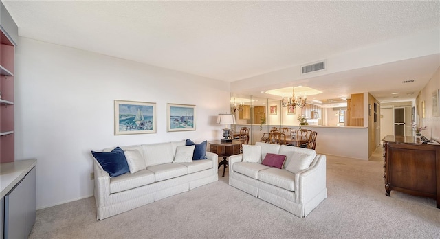 living room featuring an inviting chandelier, light colored carpet, and a textured ceiling