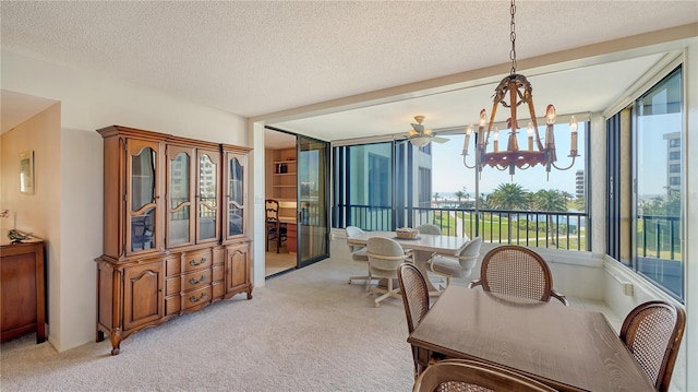 carpeted dining area with an inviting chandelier and a textured ceiling