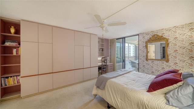 bedroom featuring light carpet, ceiling fan, a textured ceiling, and access to exterior