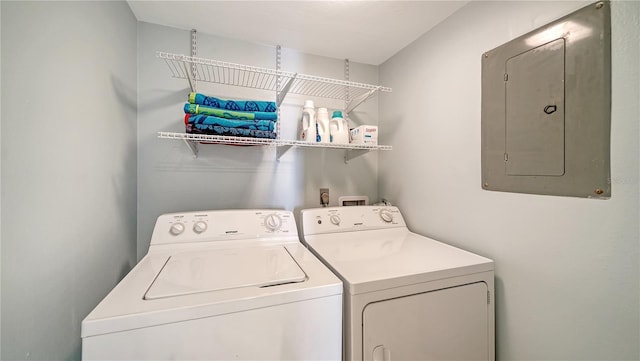 clothes washing area with electric panel and washer and dryer