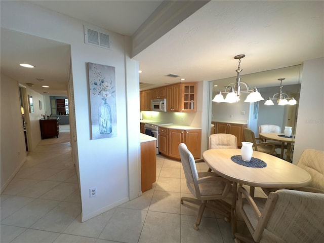 5780 Midnight Pass Rd Unit 303B, Sarasota, FL 34242 - dining area with light tile patterned flooring and a chandelier