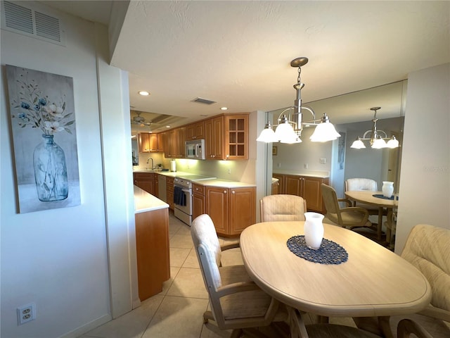 5780 Midnight Pass Rd Unit 303B, Sarasota, FL 34242 - dining room featuring a chandelier, light tile patterned floors, and recessed lighting