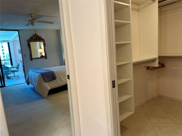 5780 Midnight Pass Rd Unit 303B, Sarasota, FL 34242 - walk in closet featuring a ceiling fan, tile patterned floors, and carpet flooring