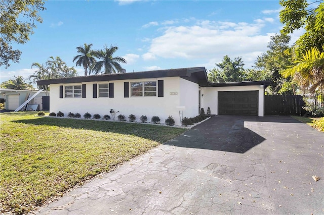 single story home with a garage and a front yard