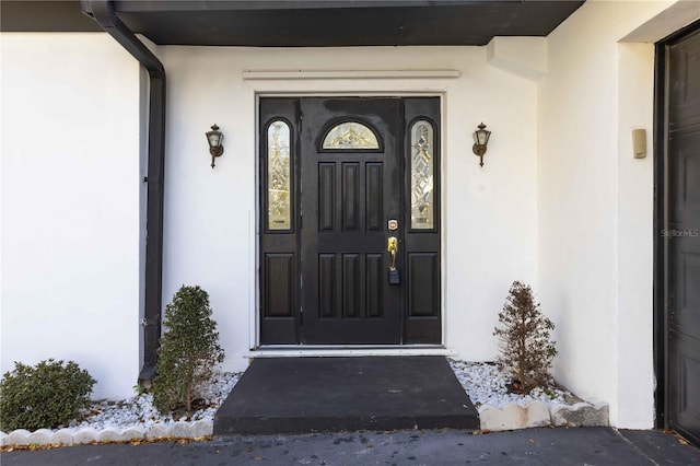 entrance to property with stucco siding