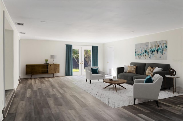 living room featuring visible vents, french doors, and wood finished floors