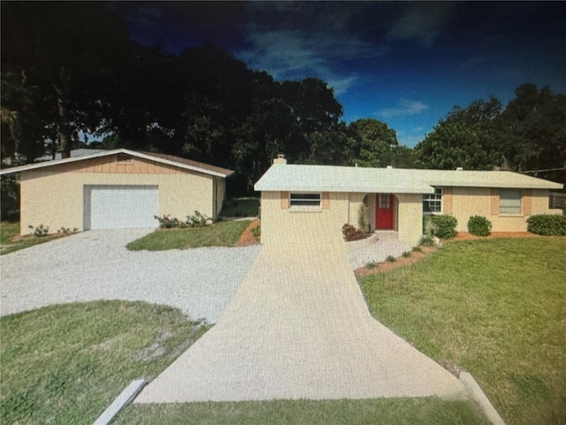 single story home with a garage and a front yard