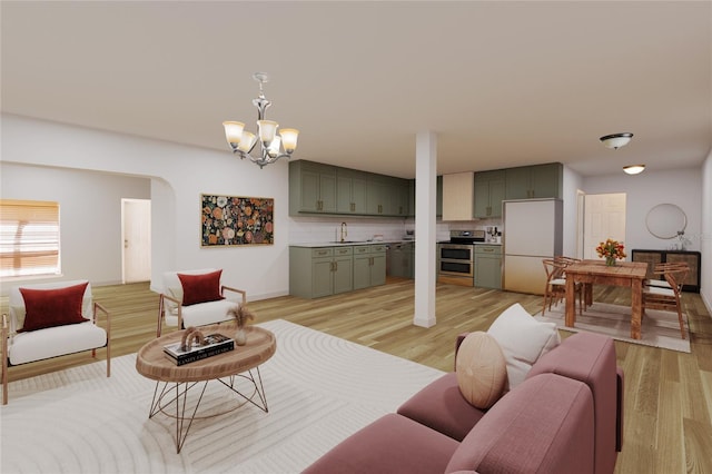 living room featuring a notable chandelier and light wood-type flooring