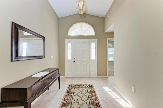 tiled foyer entrance featuring vaulted ceiling