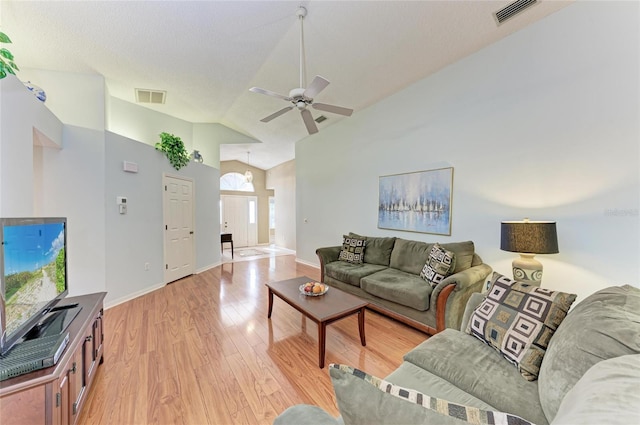 living room with high vaulted ceiling, light hardwood / wood-style floors, and ceiling fan