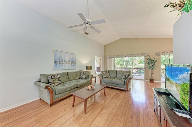 living room featuring ceiling fan, high vaulted ceiling, a textured ceiling, and light wood-type flooring