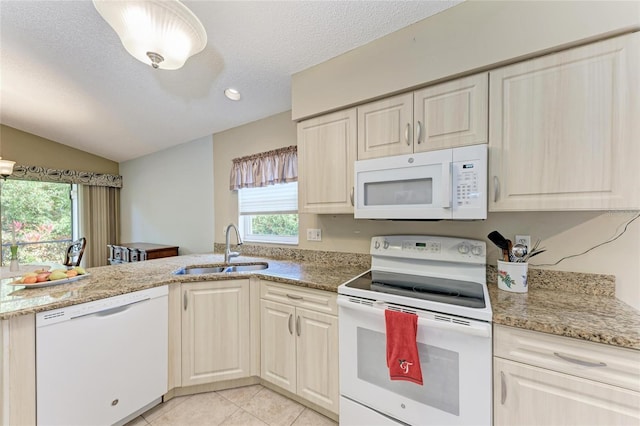 kitchen featuring sink, a textured ceiling, light tile patterned floors, white appliances, and light stone countertops