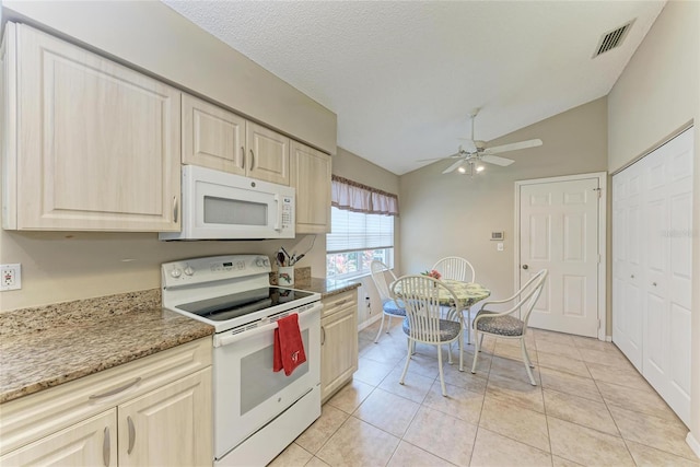 kitchen featuring lofted ceiling, light tile patterned floors, white appliances, ceiling fan, and a textured ceiling