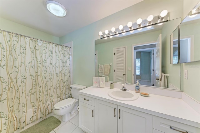 full bathroom featuring toilet, tile patterned floors, vanity, and shower / bathtub combination with curtain