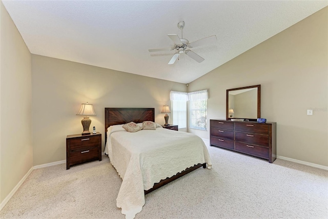 carpeted bedroom featuring ceiling fan, vaulted ceiling, and a textured ceiling