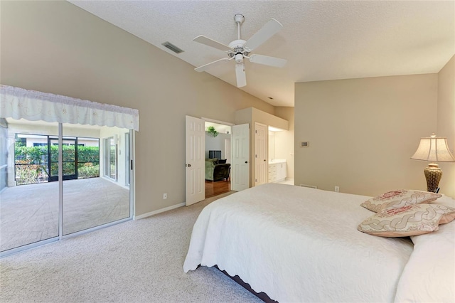 carpeted bedroom featuring lofted ceiling, ensuite bath, a textured ceiling, access to outside, and ceiling fan