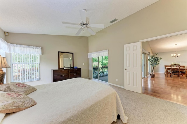 bedroom with vaulted ceiling, carpet floors, access to outside, and a textured ceiling