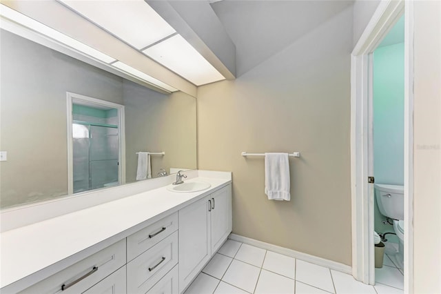 bathroom featuring a shower with door, vanity, tile patterned floors, and toilet