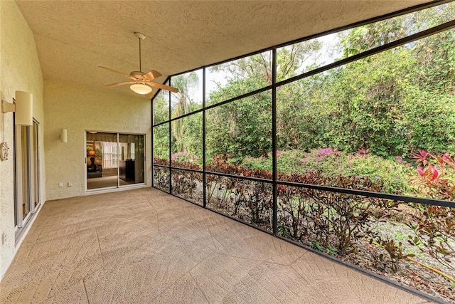 unfurnished sunroom with ceiling fan