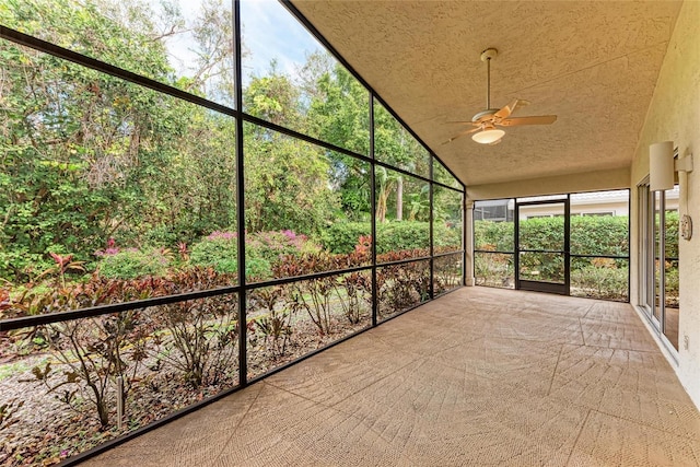 unfurnished sunroom with lofted ceiling and ceiling fan