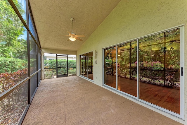 unfurnished sunroom with ceiling fan and lofted ceiling