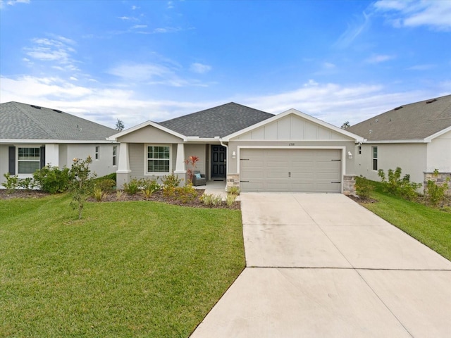 single story home featuring a garage and a front lawn