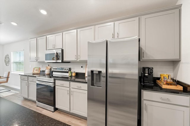 kitchen with light wood-type flooring and appliances with stainless steel finishes