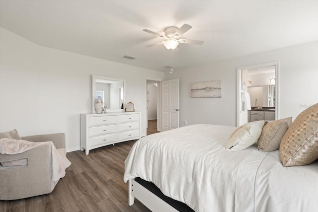 bedroom with dark wood-type flooring, ceiling fan, and ensuite bathroom