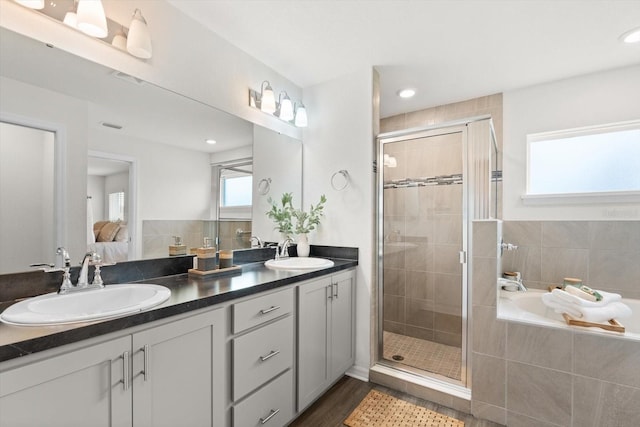 bathroom with vanity, separate shower and tub, and hardwood / wood-style floors