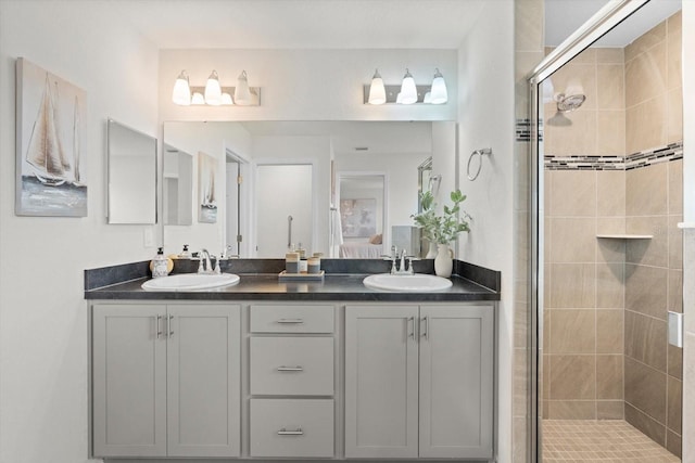 bathroom with vanity and a shower with door