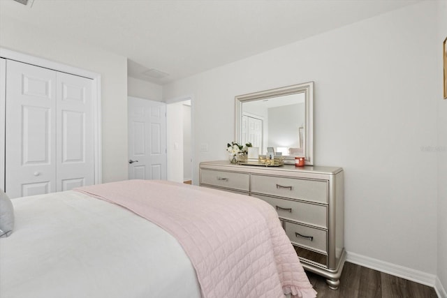 bedroom featuring dark wood-type flooring and a closet