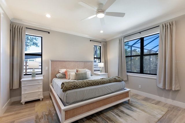 bedroom featuring multiple windows, ceiling fan, and light hardwood / wood-style flooring