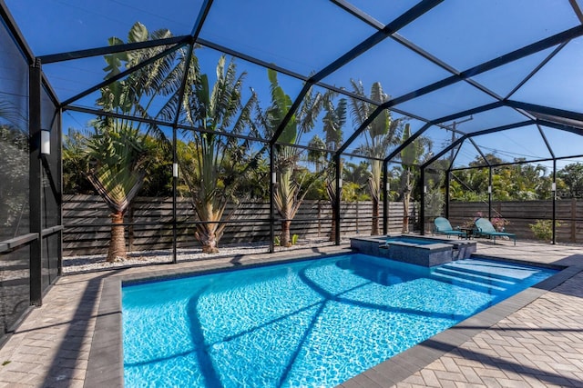 view of swimming pool featuring an in ground hot tub, a lanai, and a patio area