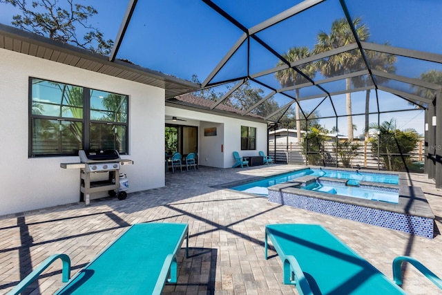 view of swimming pool with an in ground hot tub, a grill, a patio, and glass enclosure