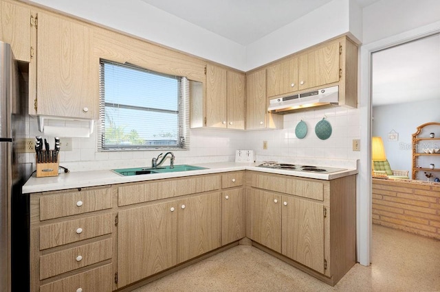 kitchen with tasteful backsplash, light brown cabinetry, sink, and white electric stovetop