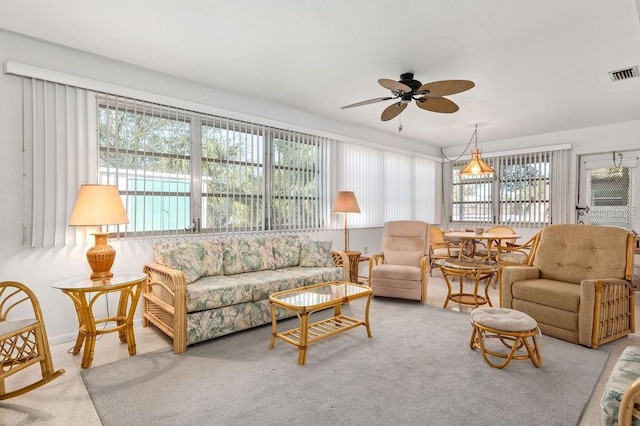 carpeted living room featuring a wealth of natural light and ceiling fan