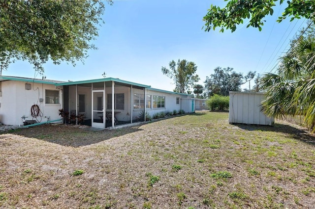 view of yard with a sunroom and a storage shed