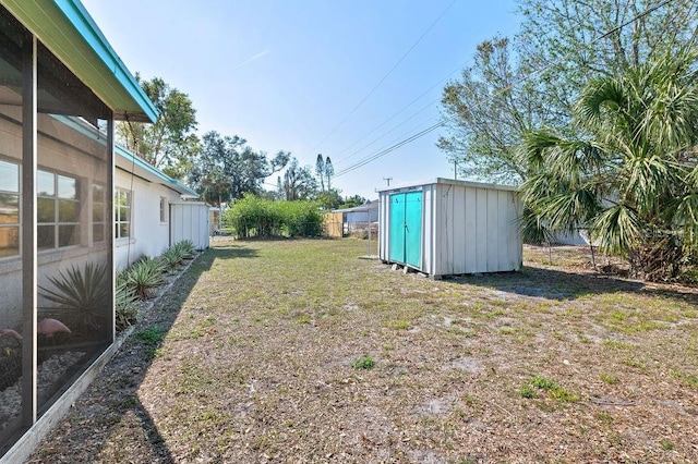 view of yard featuring a storage unit