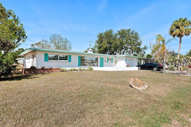 single story home with a front lawn and a carport