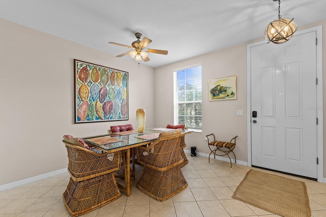 tiled dining space with ceiling fan