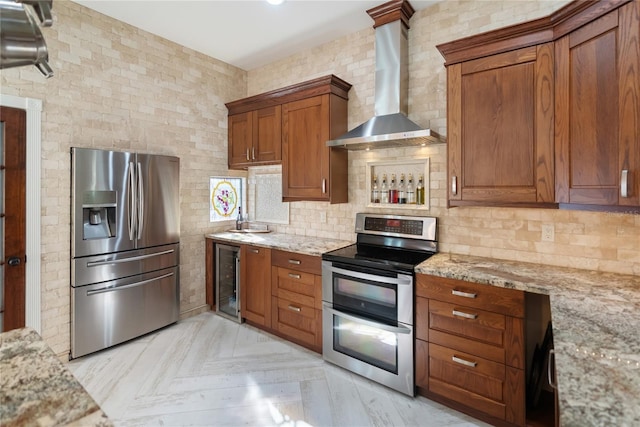 kitchen featuring wall chimney exhaust hood, tasteful backsplash, light stone counters, appliances with stainless steel finishes, and beverage cooler