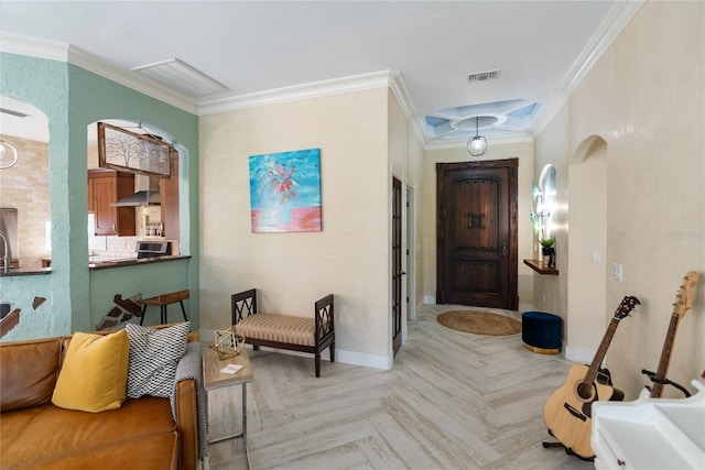 entrance foyer featuring light parquet floors and ornamental molding