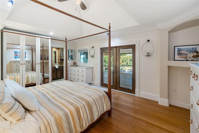 bedroom with crown molding, access to exterior, hardwood / wood-style flooring, and french doors