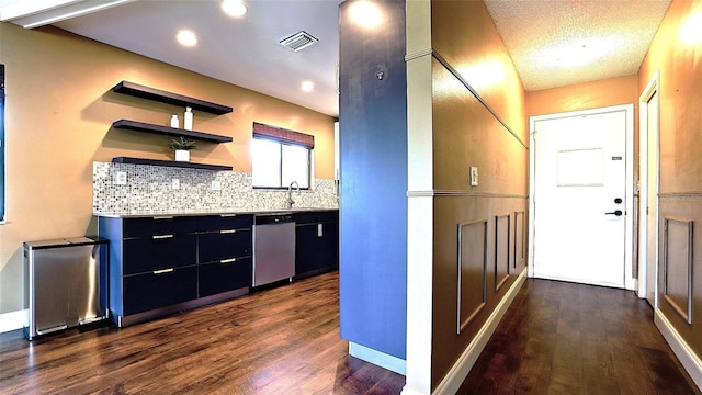 kitchen with dark wood-type flooring, sink, tasteful backsplash, a textured ceiling, and dishwasher