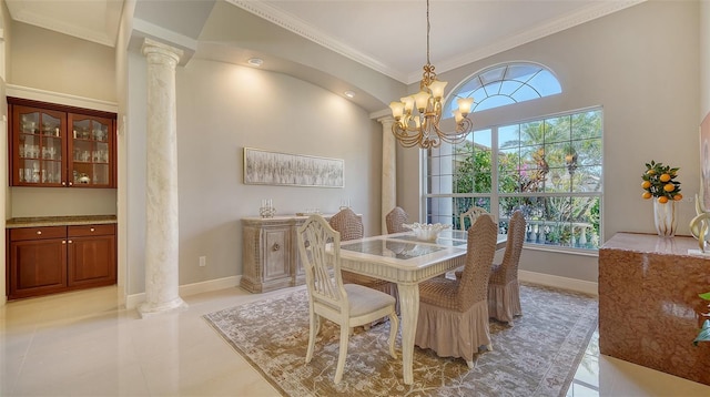 tiled dining room featuring an inviting chandelier, ornamental molding, and decorative columns