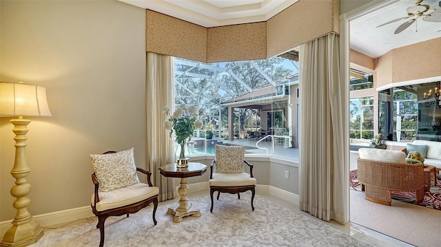 living area with ceiling fan and a wealth of natural light