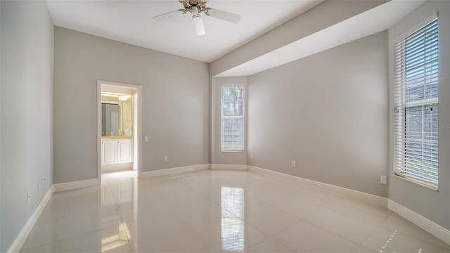 unfurnished room featuring ceiling fan and light tile patterned floors