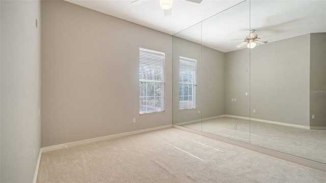 unfurnished bedroom featuring light colored carpet, ceiling fan, and a closet